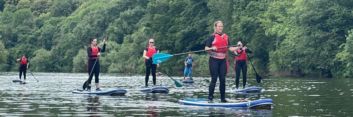 Stand-up paddle boarding team building event South Wales